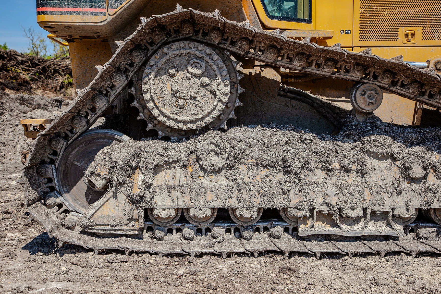 Cogmatic builds custom crawler sprockets tough enough for this abuse. Self-cleaning notches eject packed mud, while hardened flanks prevent peening and ratcheting.
